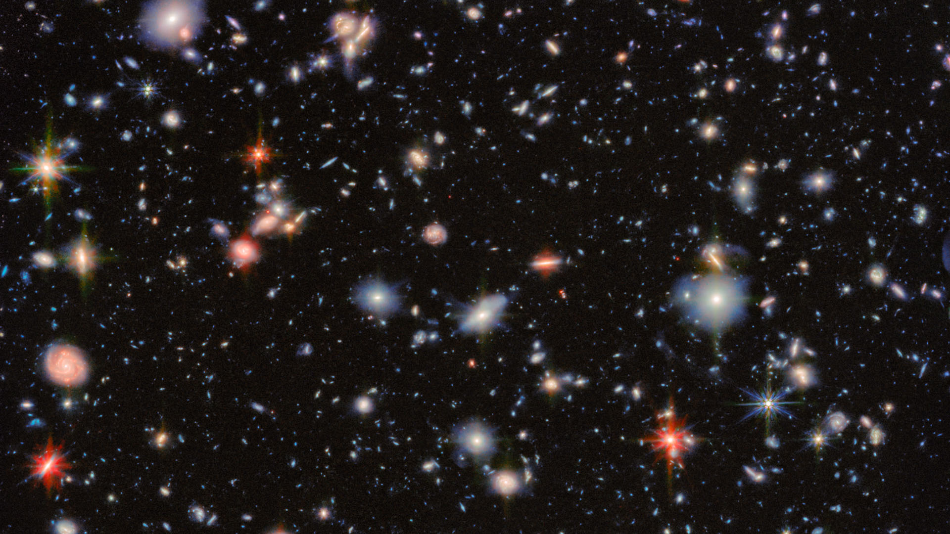 Mängder av stjärnor i olika färger mot svart bakgrund.
